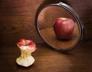 Distorted image of apple core in mirror