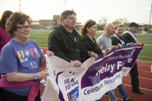 People walking holding Relay for Life Banner
