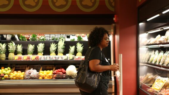 Student checking food options in store
